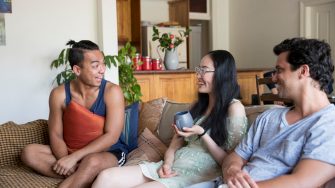 International Students hanging out on couch at home